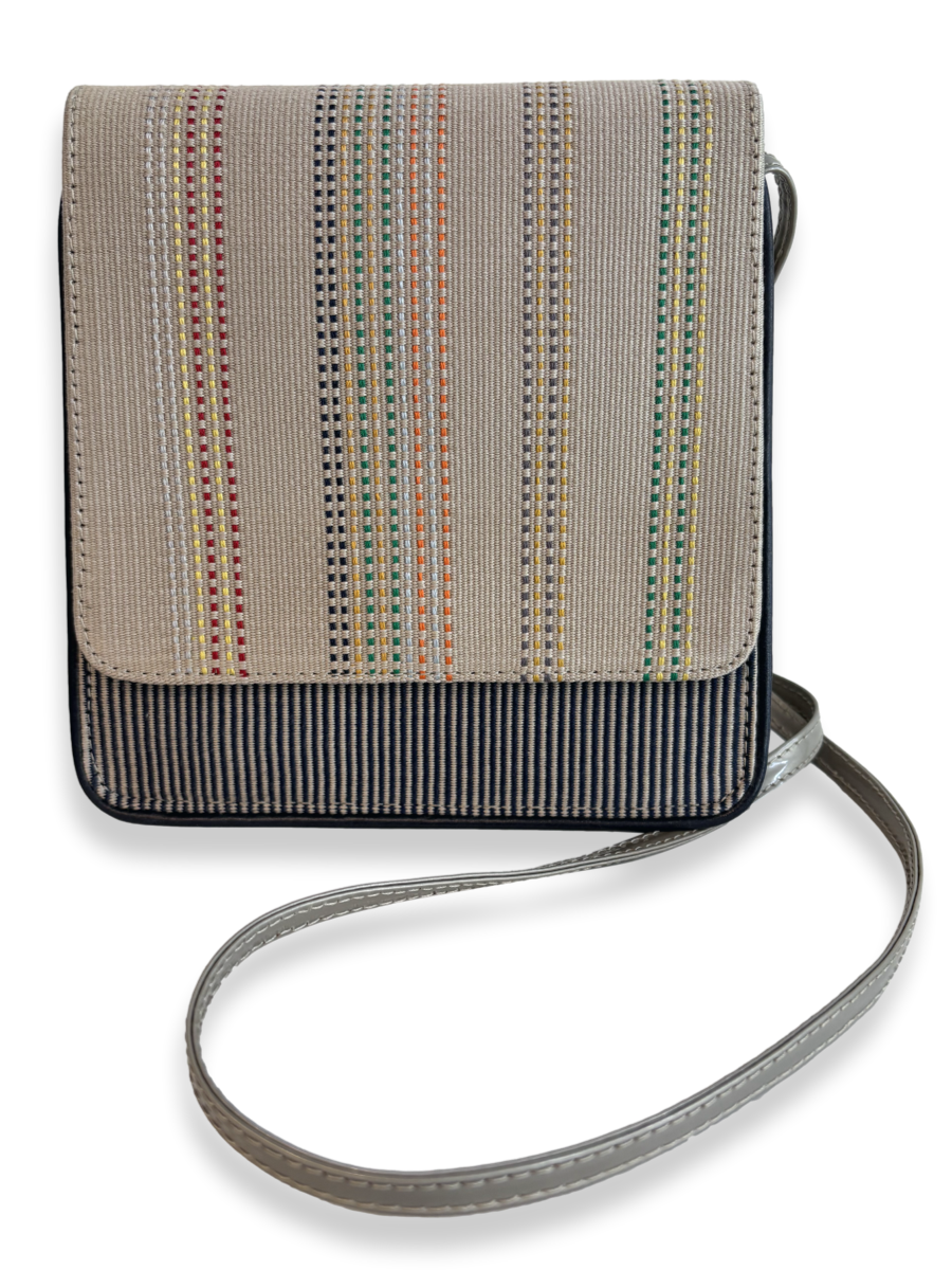 Front view of Cocktail Crossbody Handbag in woven Peruvian Pima cotton with taupe leather strap, navy leather trim and multicolor striped detailing.