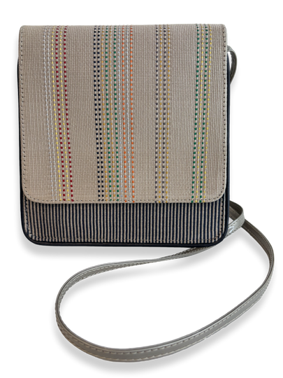 Front view of Cocktail Crossbody Handbag in woven Peruvian Pima cotton with taupe leather strap, navy leather trim and multicolor striped detailing.