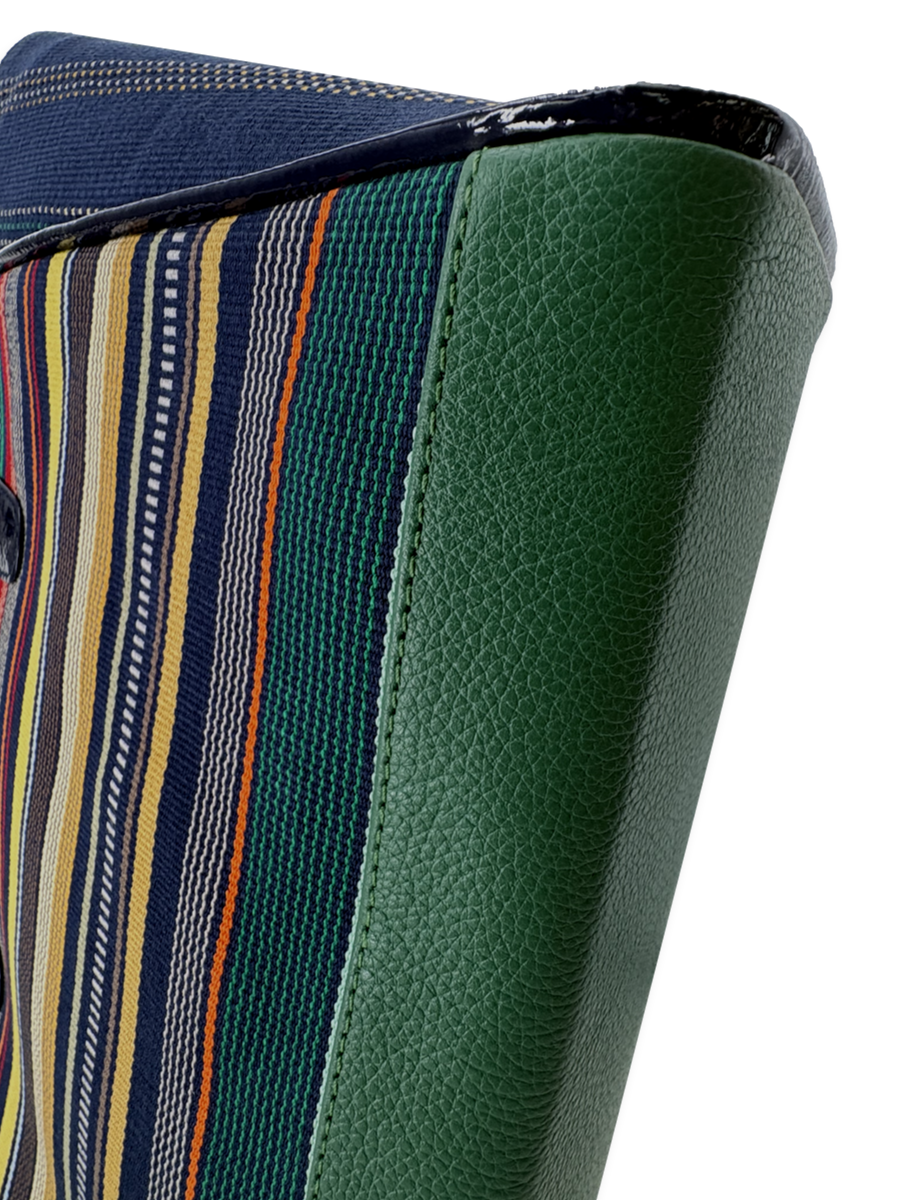 Close-up of Amanda Grande handbag showing emerald green pebbled leather trim, navy patent leather accents, and handwoven mercerized Pima cotton textile