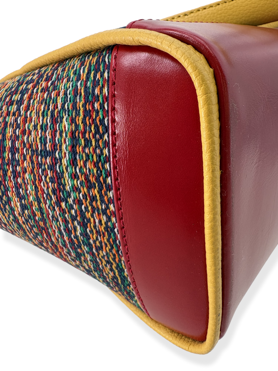 Limited-edition Amanda Grande designer handbag showcasing mercerized Peruvian Pima cotton, genuine leather detailing, structured top-handle silhouette, and sophisticated multicolor stripe pattern.