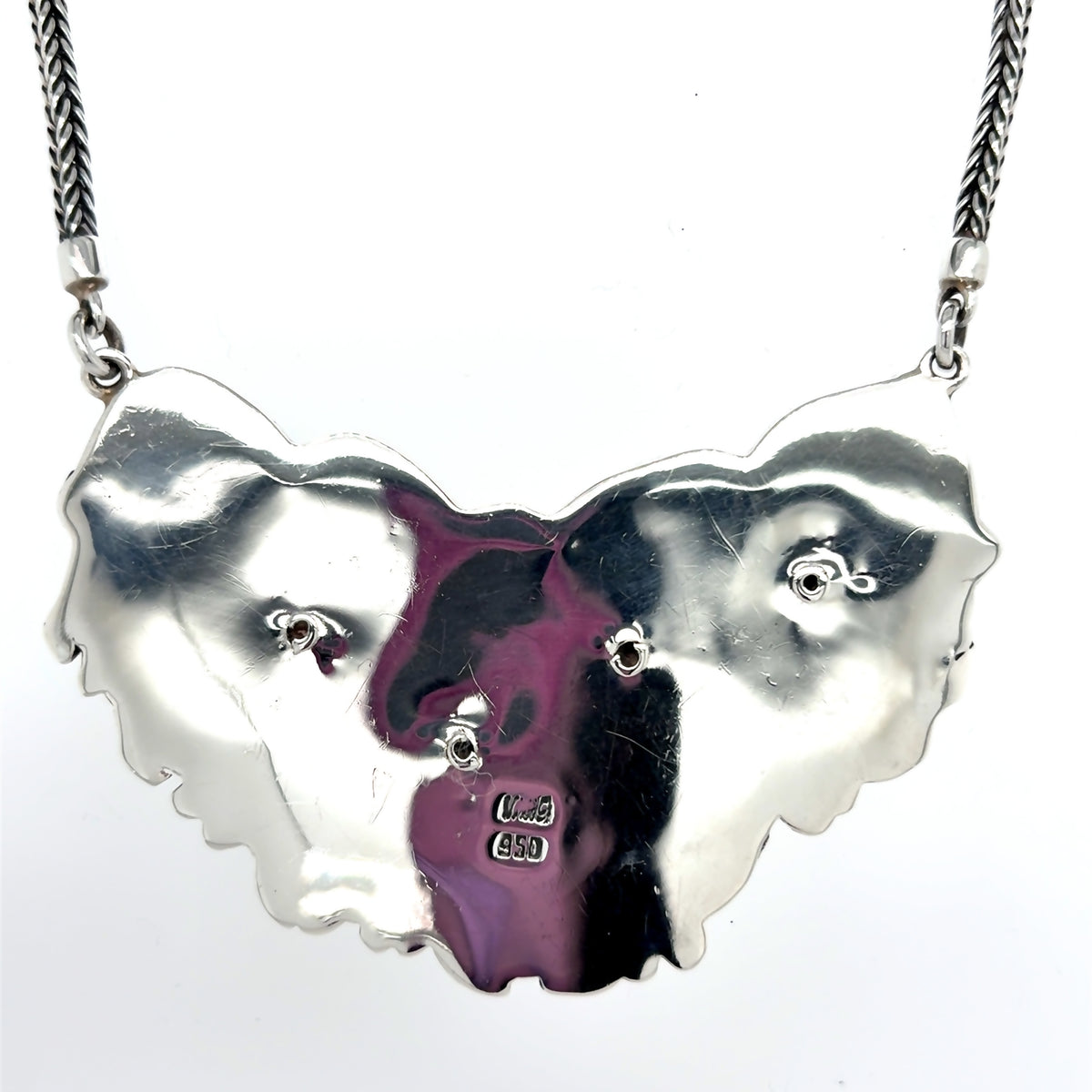 Freshwater baroque pearl bib necklace in 950 sterling silver with solid back, featuring iridescent organic pearls accented by intricate floral detailing in an elegant, sculptural design From Qinti The Peruvian Shop.