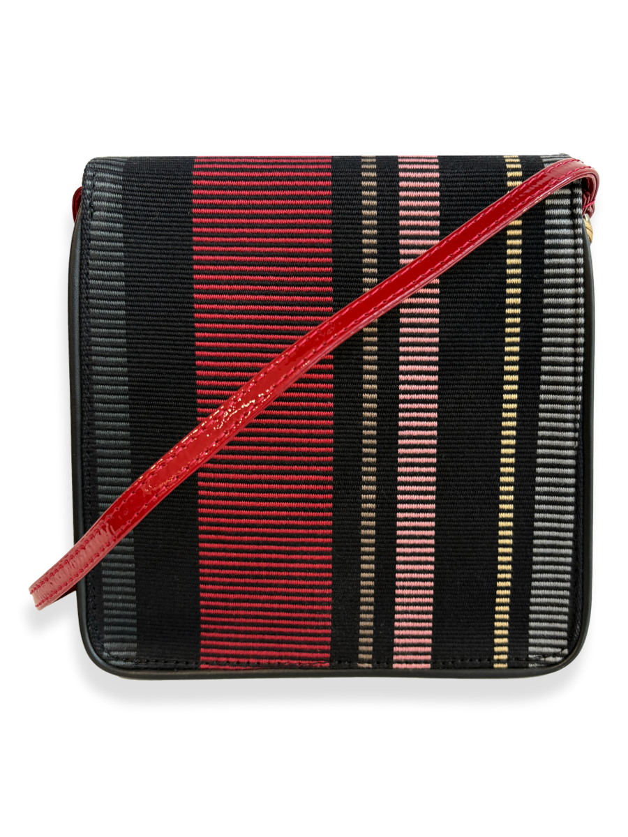 A small rectangular crossbody bag with a black and red striped woven body and a glossy red strap, shown on a plain white background.