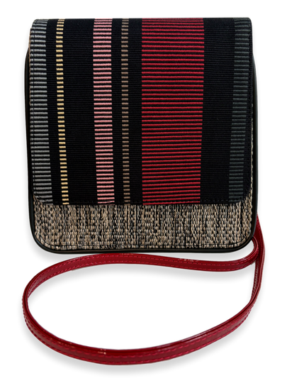 A small rectangular shoulder bag with a black and red vertically striped patterned body, a textured beige woven lower border, and a red strap, shown on a white background.