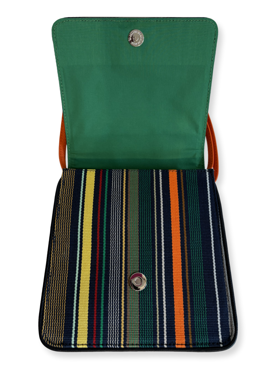 One-of-a-kind Cocktail crossbody handbag handcrafted in Peru with premium mercerized Pima cotton, navy woven textile, orange pebbled leather strap, and contemporary designer styling.