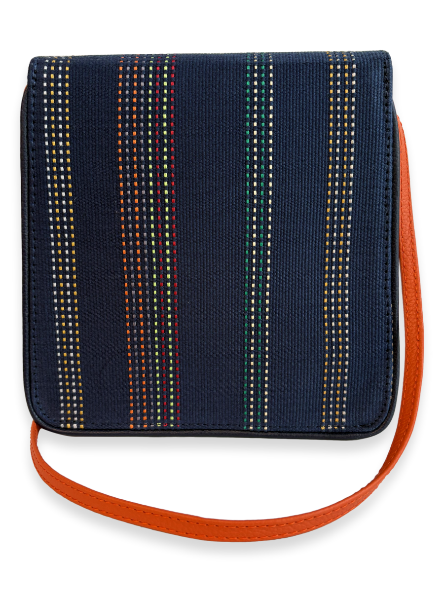 Back view of a luxury Cocktail crossbody handbag featuring handwoven mercerized Peruvian Pima cotton, navy textile design, orange pebbled leather strap, and premium craftsmanship.