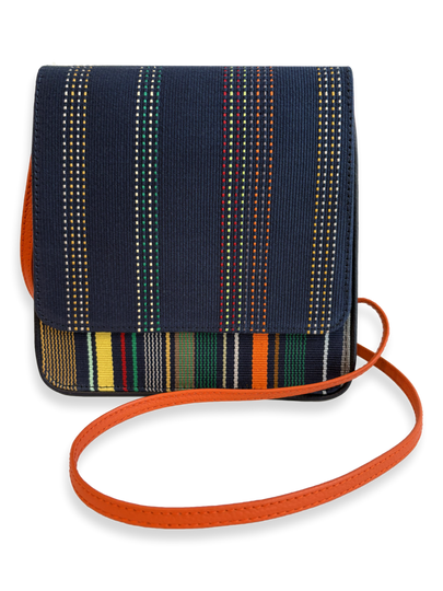 One-of-a-kind Cocktail crossbody handbag handcrafted in Peru with premium mercerized Pima cotton, navy woven textile, orange pebbled leather strap, and contemporary designer styling.