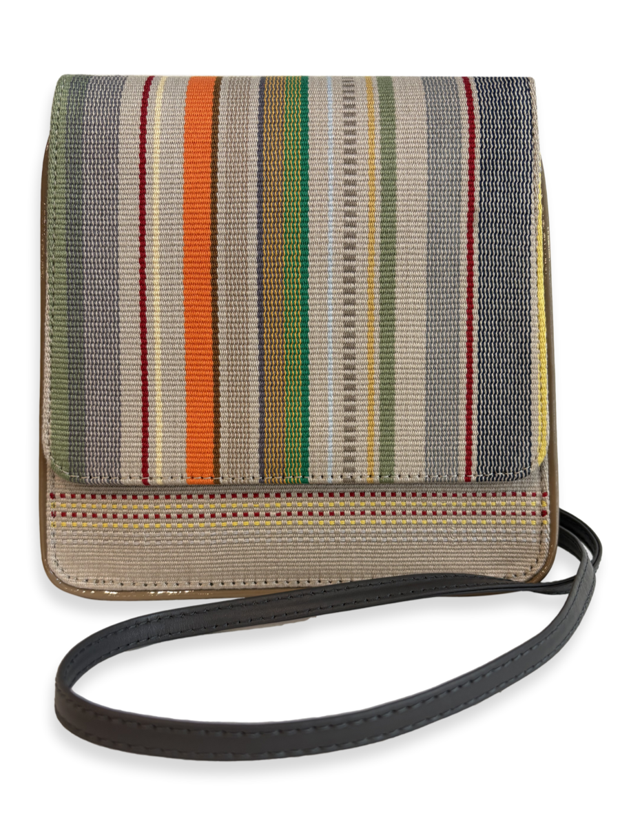 Front view of the Cocktail designer crossbody handbag featuring one-of-a-kind woven Peruvian Pima cotton in orange, green, grey and neutral stripes with genuine leather detailing.