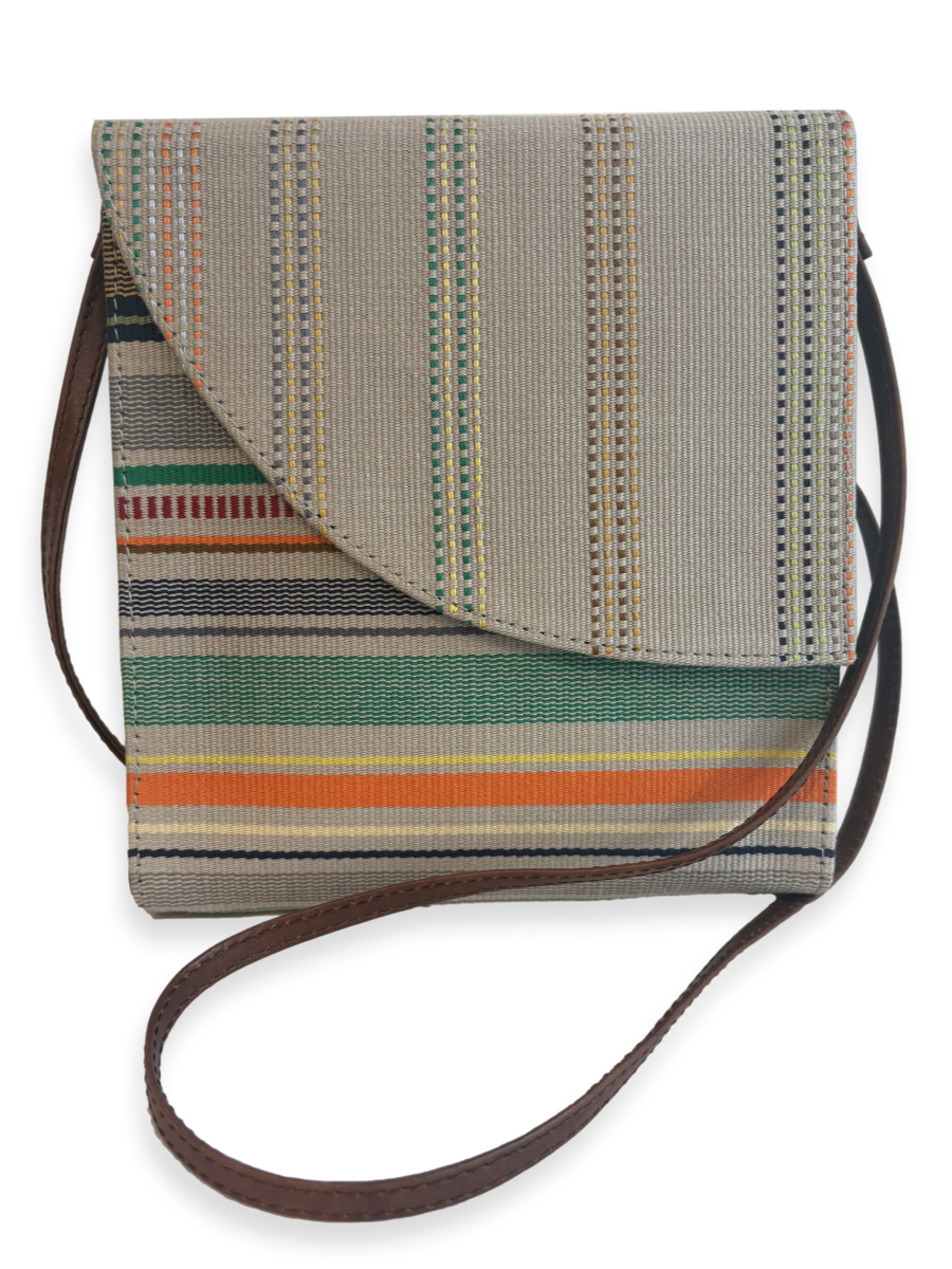 Front view of the Curva designer crossbody handbag handcrafted in Peru with premium mercerized Peruvian Pima cotton, smooth tan leather trim, striped woven textile, and adjustable leather shoulder strap.