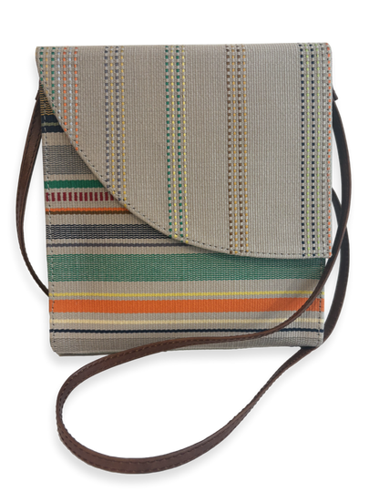 Front view of the Curva designer crossbody handbag handcrafted in Peru with premium mercerized Peruvian Pima cotton, smooth tan leather trim, striped woven textile, and adjustable leather shoulder strap.