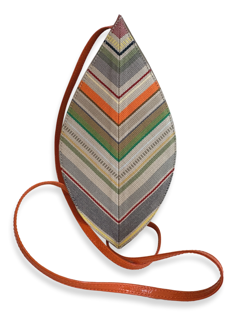 A teardrop-shaped woven crossbody bag with a multicolor chevron pattern in gray, green, orange, beige, and red, featuring a brown leather strap on a white background.