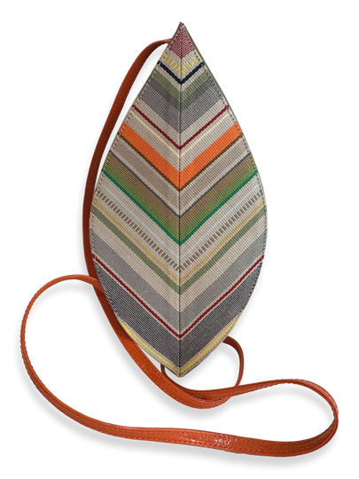 A teardrop-shaped woven crossbody bag with a multicolor chevron pattern in gray, green, orange, beige, and red, featuring a brown leather strap on a white background.