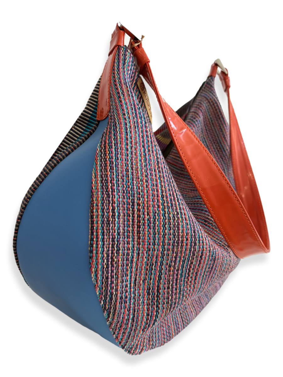 One-of-a-kind Media Luna handbag by Kuskaya made from mercerized Pima cotton from Peru, featuring a crescent shape, multicolored striped textile, double-sided design, and leather trim with a wide shoulder strap. From QINTI The Peruvian Shop.