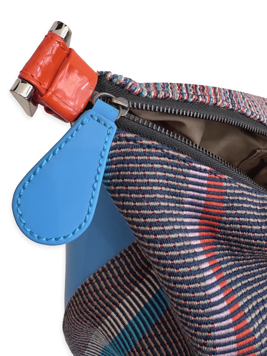 One-of-a-kind Media Luna handbag by Kuskaya made from mercerized Pima cotton from Peru, featuring a crescent shape, multicolored striped textile, double-sided design, and leather trim with a wide shoulder strap. FromQINTI The Peruvian Shop. CLOSE-UP