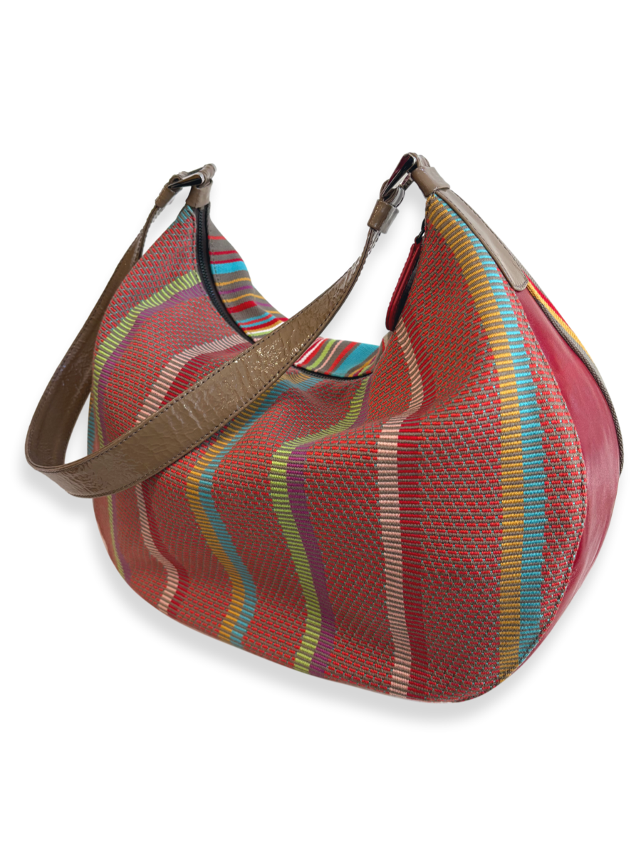 KUSKAYA one-of-a-kind shoulder bag made from handwoven Pima cotton and leather, featuring red base with vibrant multicolor stripes