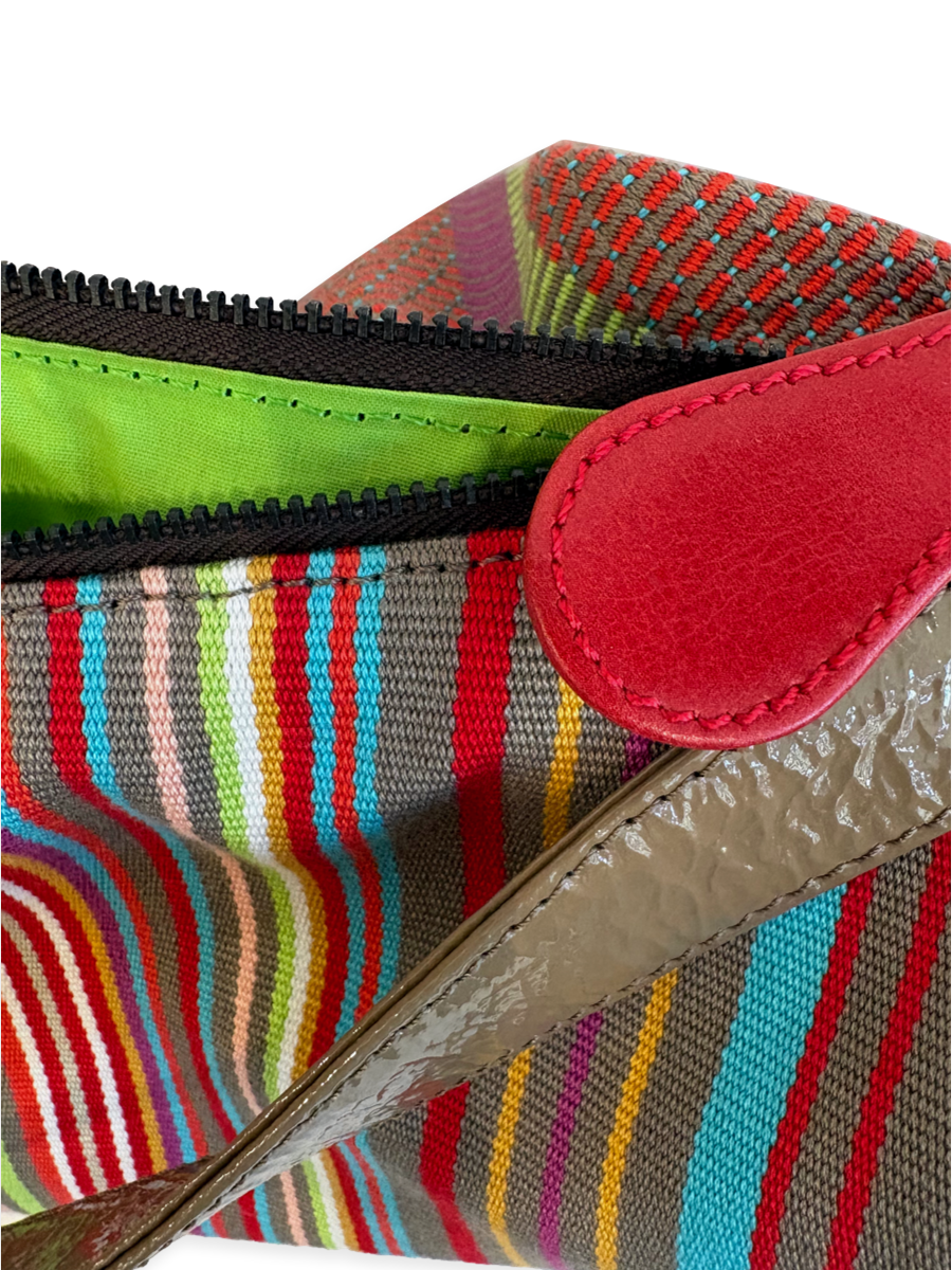 KUSKAYA one-of-a-kind shoulder bag made from handwoven Pima cotton and leather, featuring red base with vibrant multicolor stripes