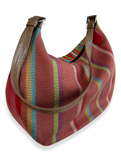 Side view of handwoven Pima cotton handbag with colorful striped pattern and leather trim, medium hobo-style shoulder bag