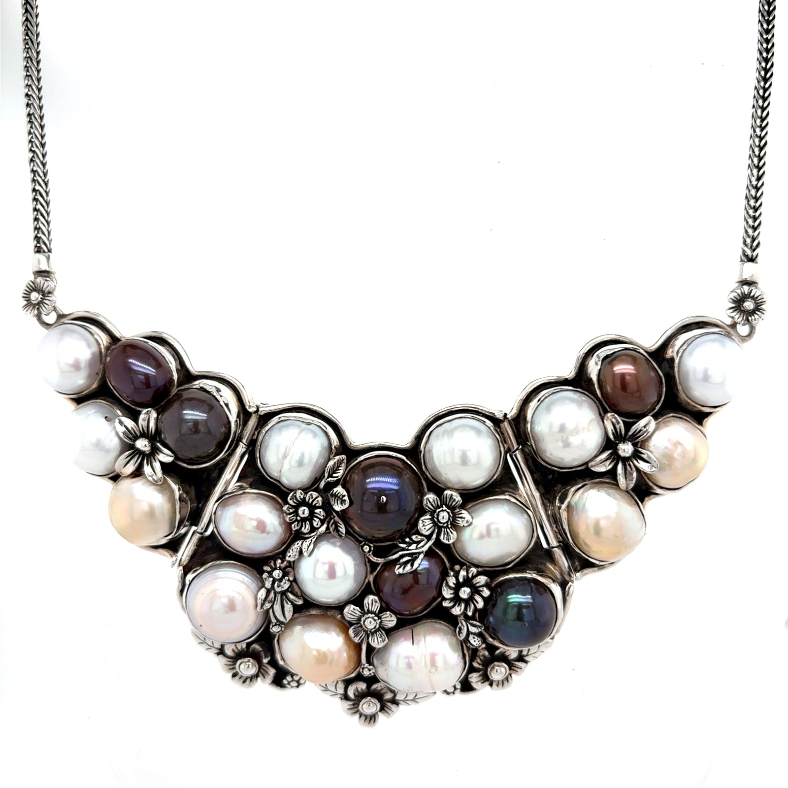 Multicolor freshwater pearl bib necklace in 950 sterling silver with solid back, featuring white, pink, peach, and dark pearls in an ornate floral cluster design  QINTI The Peruvian Shop