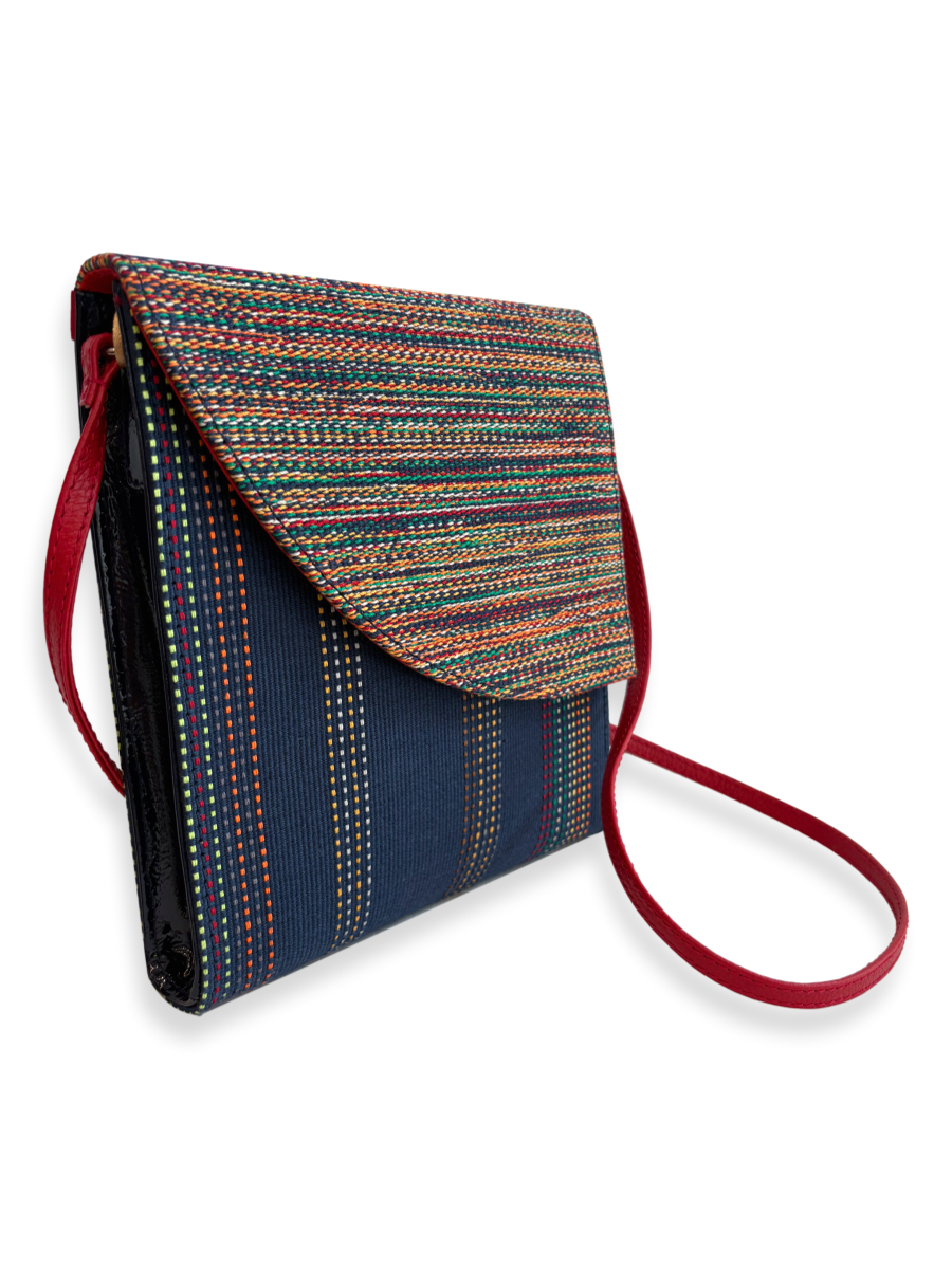 One-of-a-kind Pima cotton crossbody handbag by Kuskaya, featuring a multicolor woven flap, navy striped body, and red leather strap, available at Qinti The Peruvian Shop.