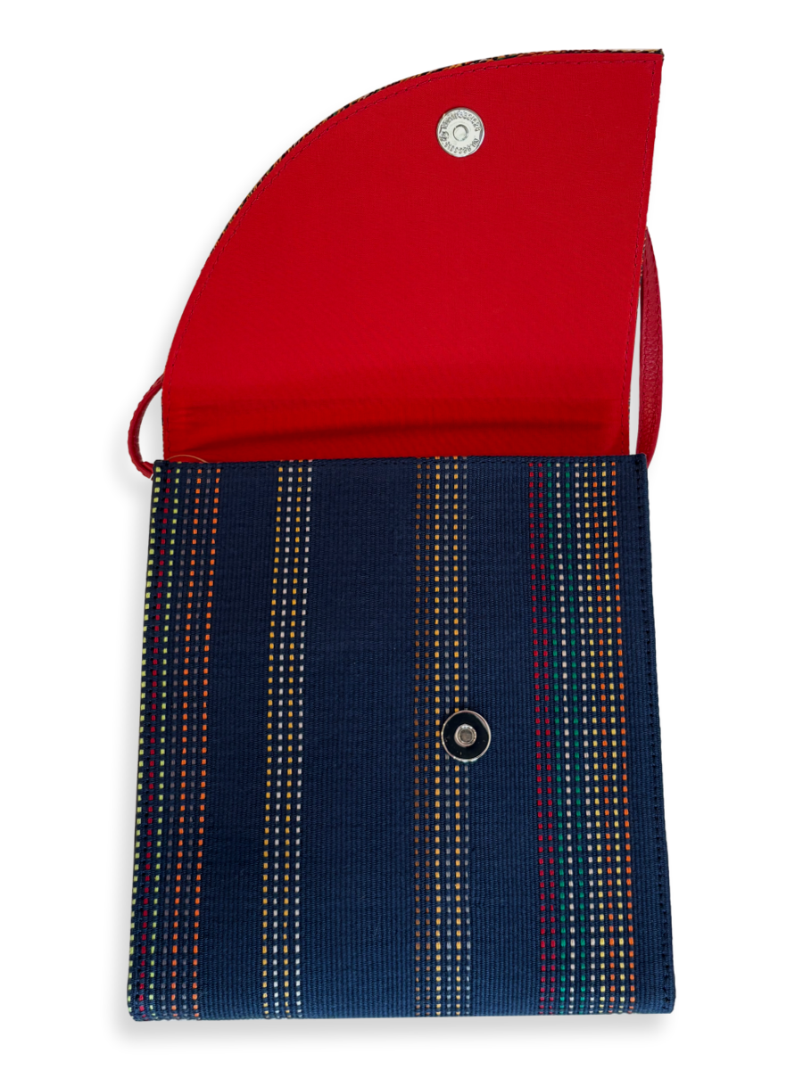 One-of-a-kind Pima cotton crossbody handbag by Kuskaya, featuring a multicolor woven flap, navy striped body, red leather strap and interior, available at Qinti The Peruvian Shop.