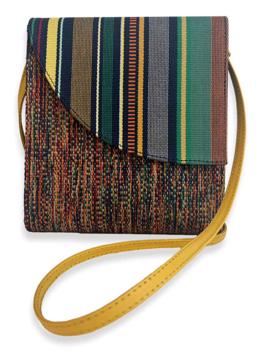 Front view of the Curva Navy Multi luxury crossbody handbag featuring premium mercerized Peruvian Pima cotton, one-of-a-kind woven textile, yellow pebbled leather trim, adjustable leather strap, and handcrafted design from Peru.