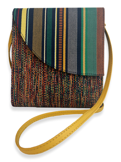 Front view of the Curva Navy Multi luxury crossbody handbag featuring premium mercerized Peruvian Pima cotton, one-of-a-kind woven textile, yellow pebbled leather trim, adjustable leather strap, and handcrafted design from Peru.