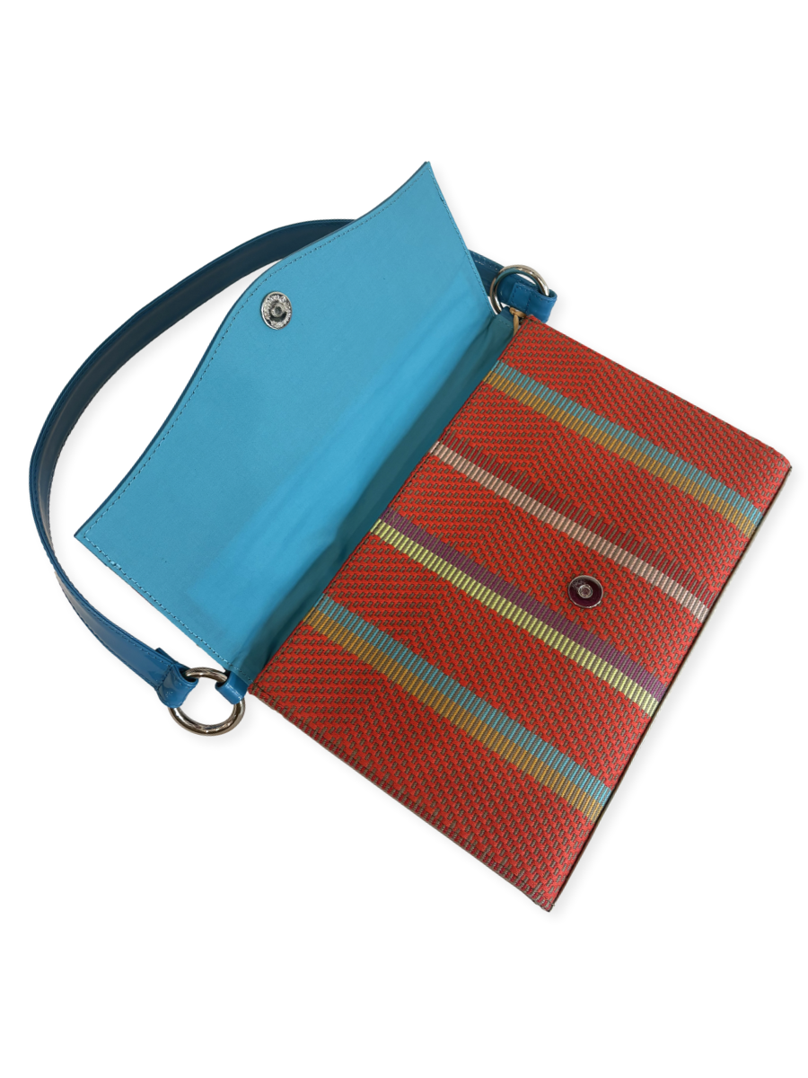 Multicolored striped bag with a blue strap made with mercerized pima cotton and patent leather with blue interior. Designed by kuskaya and sold at qinti the pweruvian shop