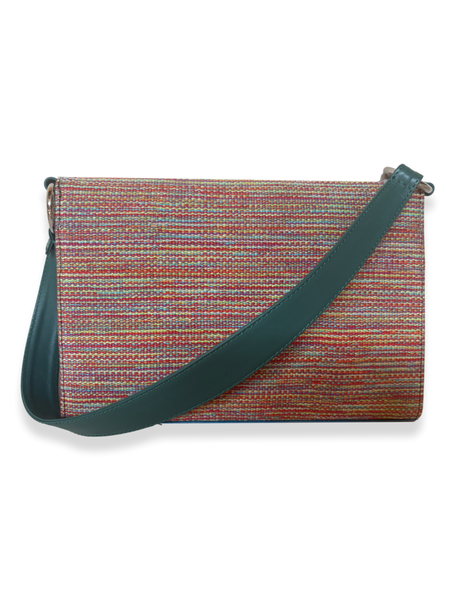 One-of-a-kind Onda designer handbag crafted from mercerized Peruvian Pima cotton with teal leather shoulder strap, featuring a multicolored woven textile exterior and contemporary luxury styling.