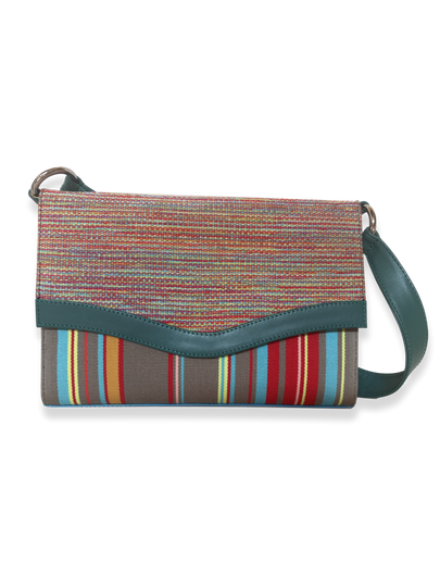 Onda luxury shoulder bag crafted from mercerized Peruvian Pima cotton with signature wave-inspired flap, teal leather trim, turquoise patent leather accents, and colorful woven textile design.