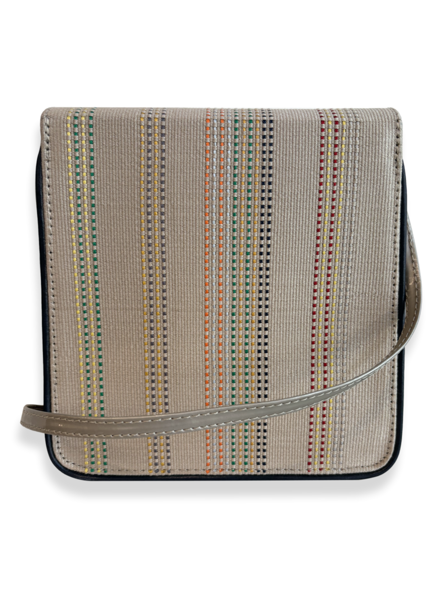Reverse view of the Cocktail designer crossbody bag featuring individually woven mercerized Peruvian Pima cotton, taupe leather strap and navy leather edging.