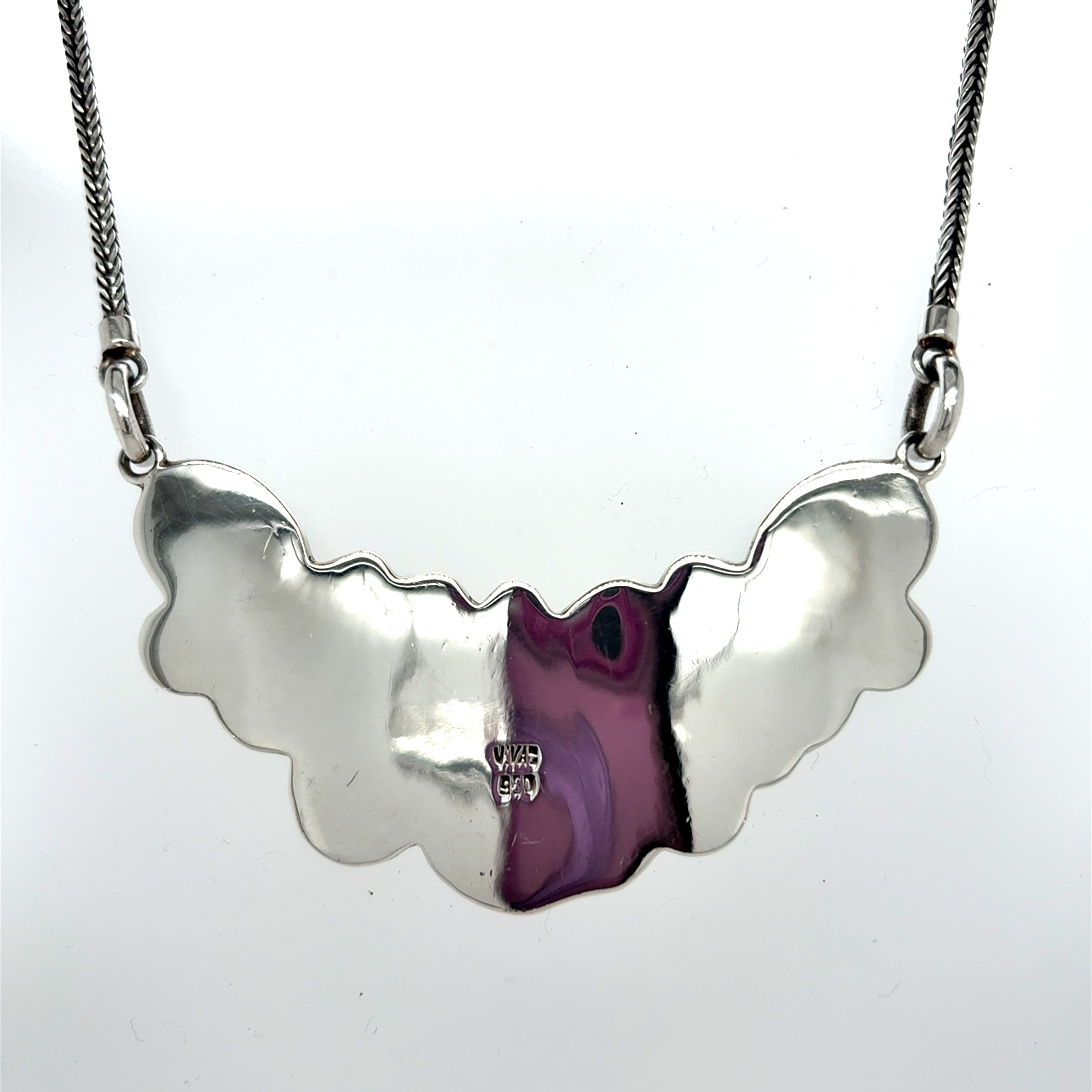 Back view of handcrafted solid 950 sterling silver necklace showing smooth polished surface and artisan stamp on the reverse side. Handcrafted 950 sterling silver necklace with multiple teardrop-shaped mother of pearl stones and floral detailing on a silver chain, front Qinti The Peruvian Shop.