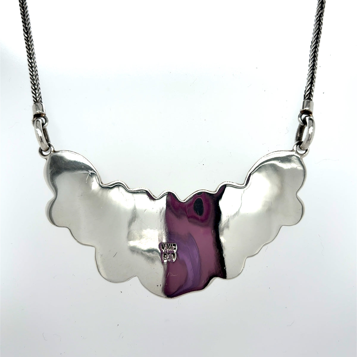 Back view of handcrafted solid 950 sterling silver necklace showing smooth polished surface and artisan stamp on the reverse side. Handcrafted 950 sterling silver necklace with multiple teardrop-shaped mother of pearl stones and floral detailing on a silver chain, front Qinti The Peruvian Shop.