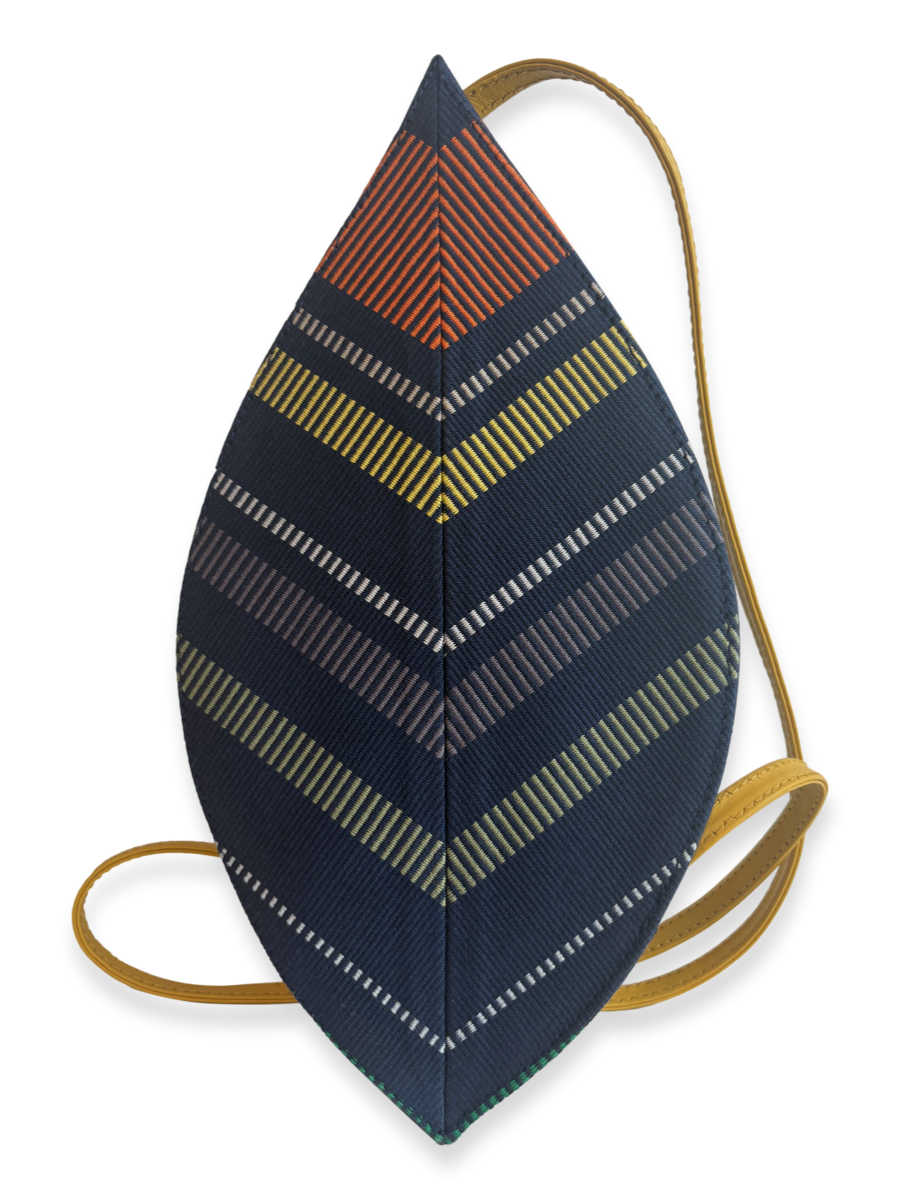 Reverse view of the Hoja Navy Multi 01 designer crossbody bag featuring a distinctive woven Peruvian Pima cotton pattern, yellow leather strap and navy leather base.
